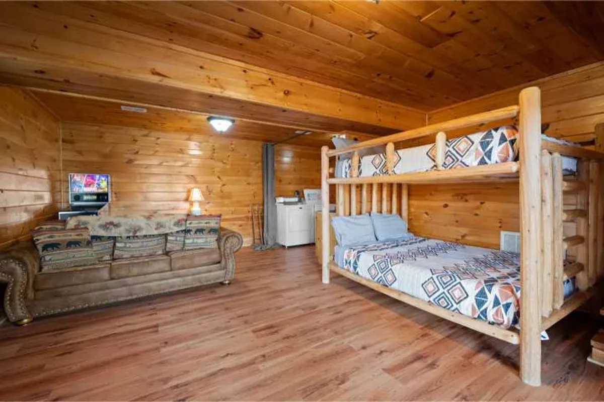 A family-friendly interior with a bunk bed, a comfortable sofa, TV, and a laundry area. The space is designed for playing games, watching TV, or sharing laughter before bed, with an overall relaxed and playful mood.