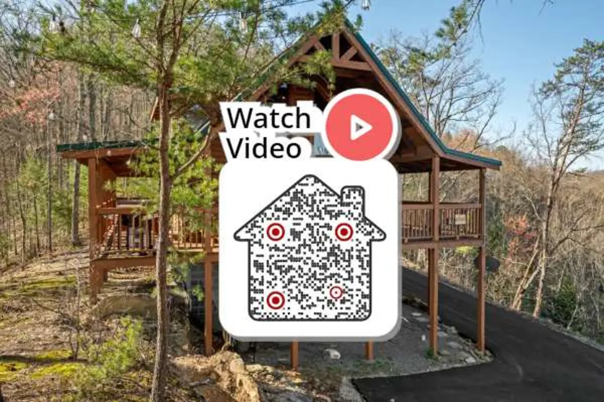 A wide shot of the log cabin’s exterior shows its rustic structure nestled among tall trees, with a spacious deck area perfect for outdoor gatherings or morning coffee. The atmosphere is serene yet welcoming, highlighting the cabin’s blend of seclusion and accessibility to adventure.